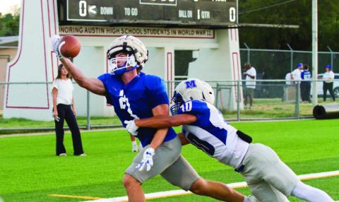 Brayden McLoughlin reaches for a one-handed snag in a scrimmage versus McCallum High on Aug. 20 in Austin. ERICK MITCHELL | DISPATCH RECORD