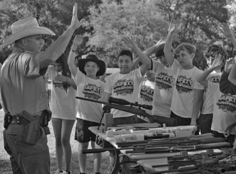 Texas Game Warden Shaun Bayless provides gun safety instruction to students during last week’s Ag Safety Day at Hanna Springs Elementary School. ERICK MITCHELL | DISPATCH RECORD