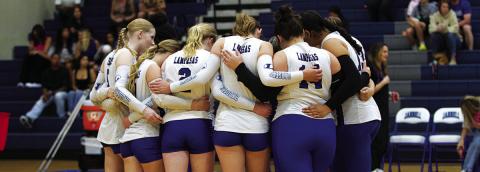 FILE PHOTO The Lady Badger volleyball players huddle up before a game on the road this past season.