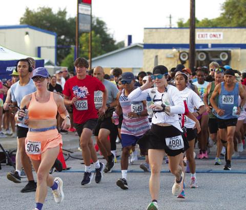 HUNTER KING | DISPATCH RECORD Runners break off for the start of the 10k race at 7 a.m. Saturday morning.