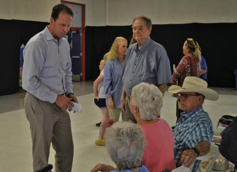 Congressman August Pfluger, at left, visits with constituents Tuesday before the start of his town hall gathering in Lampasas. A member of the Air Force Reserves, Pfluger spent time this summer in the Middle East and offered his thoughts about the status of the U.S. military. ERICK MITCHELL | DISPATCH RECORD