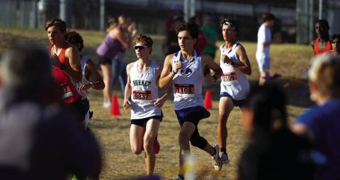 Royce Clary, left, and Tyler Ecker race around the trail during the district cross country meet. HUNTER KING | DISPATCH RECORD