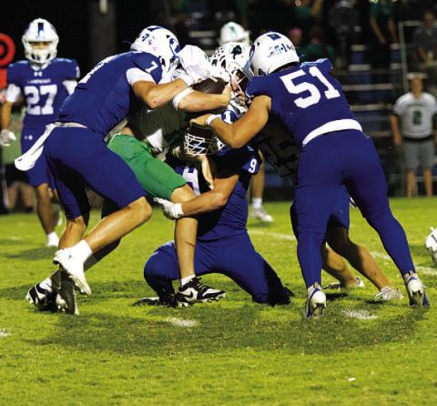 Four Badgers are in on the tackle of the Burnet ball carrier last week. HUNTER KING | DISPATCH RECORD