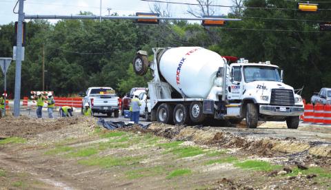 TxDOT contractors work near the Lampasas High School entrance on Thursday afternoon. ERICK MITCHELL | DISPATCH RECORD