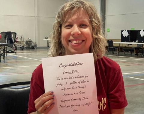 Candice Valdez received a certificate marking her two-gallon donation milestone. COURTESY PHOTO