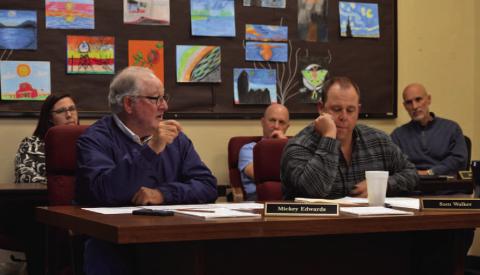 Trustees Mickey Edwards, left, and Sam Walker review construction numbers for bond propositions that are planned to go before voters in May. ERICK MITCHELL | DISPATCH RECORD