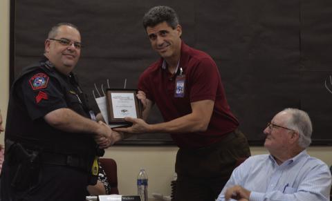 School Resource Officer Steve Sheldon, at left, was recognized at the Lampasas ISD Board of Trustees meeting where Superintendent Dr. Chane Rascoe presents the outgoing sergeant with a plaque honoring his service to the community. Sheldon plans to retire from the Lampasas Police Department at the end of June. Also pictured, at right, is trustee Mickey Edwards. ERICK MITCHELL | DISPATCH RECORD