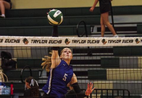 Outside hitter Mattie McBeth finishes her swing into a kill, one of 12 she had in the four-set win over Taylor on Tuesday. McBeth has amassed over 250 career kills with the Lady Badgers. ANA SOFIA MEYER | DISPATCH RECORD
