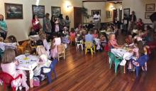 Children dressed in their party finest enjoy an afternoon tea. COURTESY PHOTO