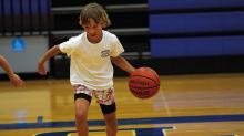 Kaylor Chapa dribbles as the kids compete in a game at the end of the first day of camp. HUNTER KING | DISPATCH RECORD