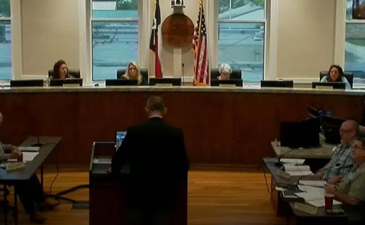 City Manager Finley deGraffenried, standing at podium, speaks to the Lampasas City Council last week about the municipal budget for Fiscal Year 2022. Presentation of a proposed budget will begin in June. SCREENSHOT FROM CITY OF LAMPASAS YOUTUBE CHANNEL