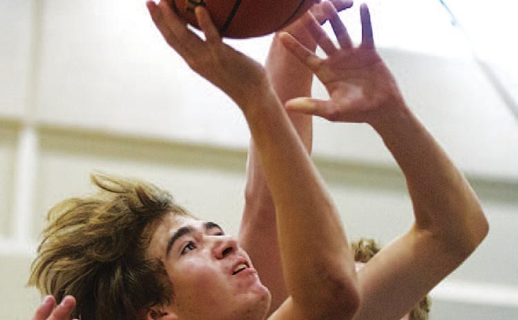 HUNTER KING | DISPATCH RECORD Jax Pratus finishes a layup through contact during Tuesday’s game against Richland Springs.