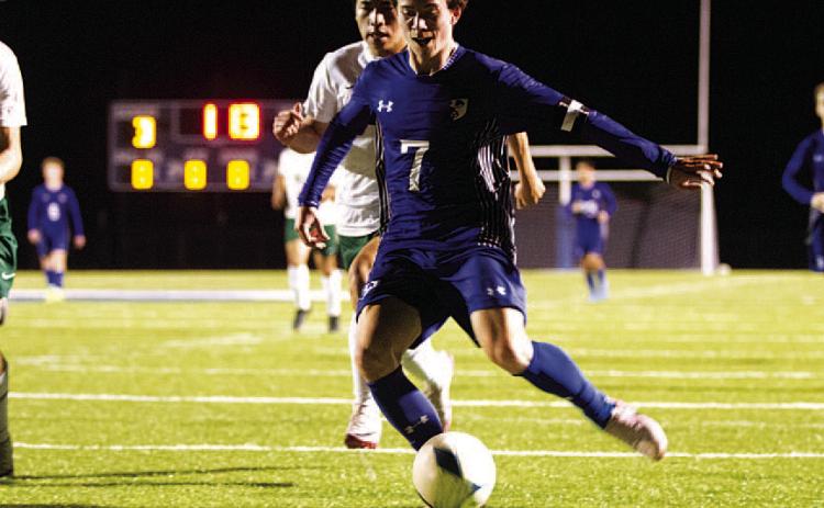 HUNTER KING | DISPATCH RECORD Cooper Pfaltzgraff shoots with his left foot to score against Academy last Friday night.