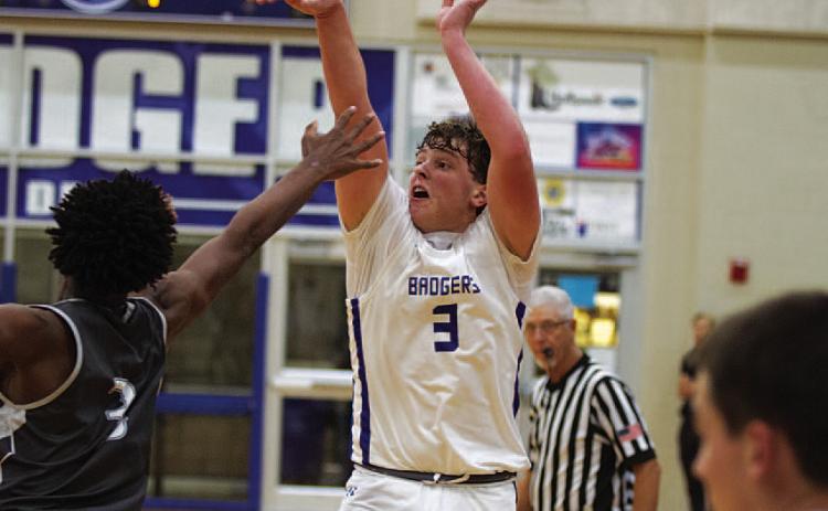 HUNTER KING | DISPATCH RECORD Aidan Nuckles shoots over an outstretched hand to knock down one of his three long-range shots during the season opener.