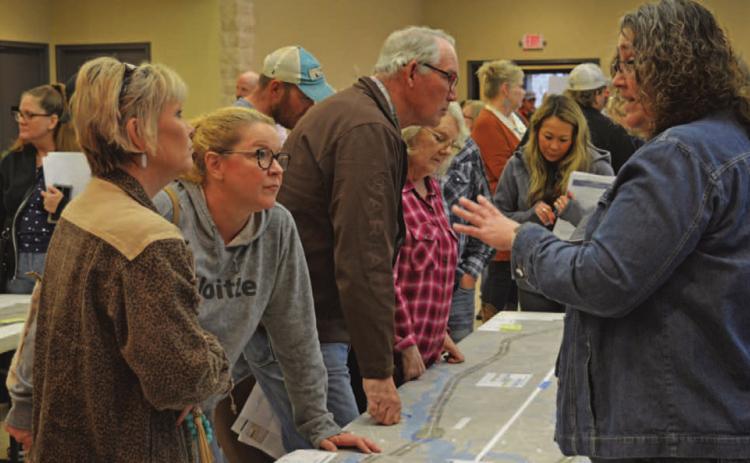 Tamara Hamm, at left, and Debra Shutts speak with TxDOT officials concerning the proposed U.S. Highway 281 Lampasas-to-Evant expansion project. ERICK MITCHELL | DISPATCH RECORD