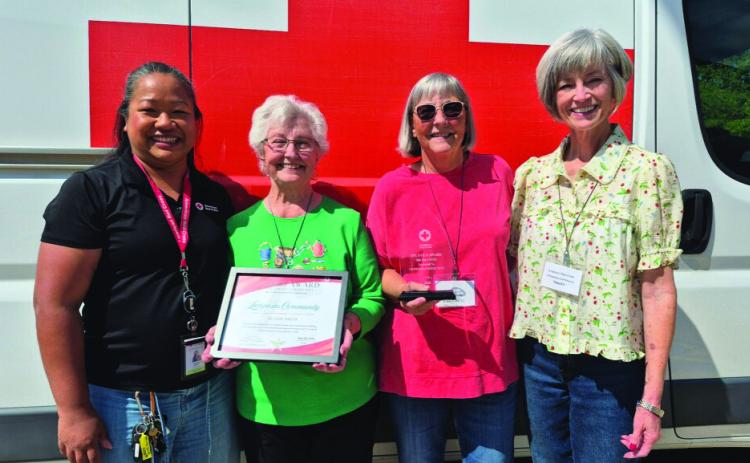 American Red Cross presented an award to Lampasas for its successful blood drive donations. Pictured are, from left to right, Robeap Santos of the American Red Cross; Wanda Lang, blood program leader for Lampasas; and Sharon Hague and Tracey Aaron, local blood drive volunteers. COURTESY PHOTO
