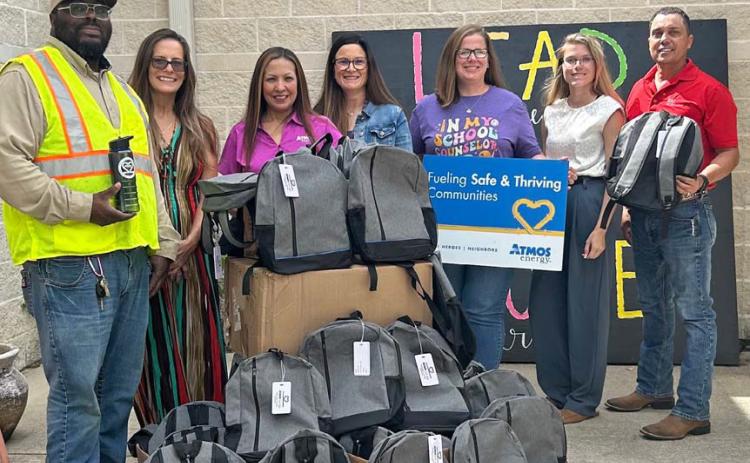 Atmos Energy makes backpack donations to local schools