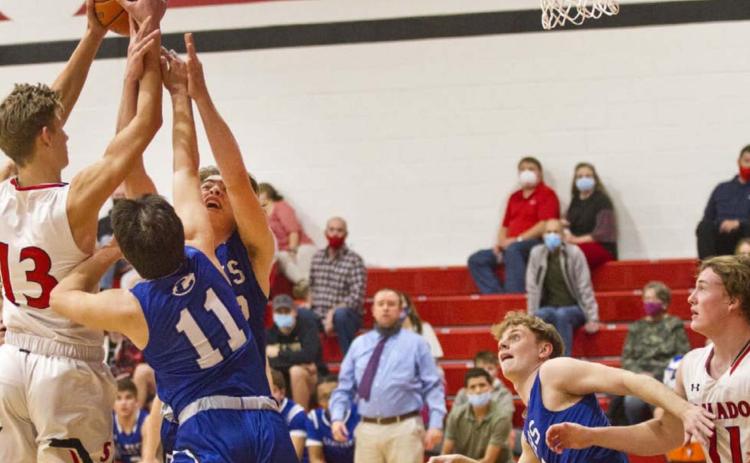 Tak Stinnett (11) and Landon Mulcahy go for a rebound as Quinn Pace (second from right) blocks out against Salado last Tuesday. Lampasas (16-1) brings a 15-game winning streak into the Jan. 12 district opener at Stephenville. On Friday, the Badgers will host No. 21 Glen Rose. JEFF LOWE | DISPATCH RECORD