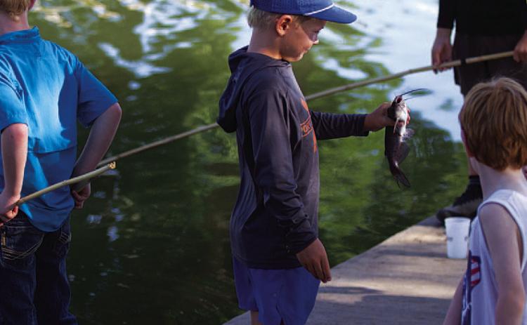 HUNTER KING | DISPATCH RECORD Bear Orlando shows off a catfish he caught on Wednesday.