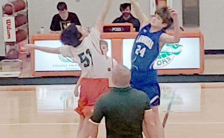 Calum Mitchell (24) goes for the opening tipoff in the seventh-grade “A” boys’ game. COURTESY PHOTO