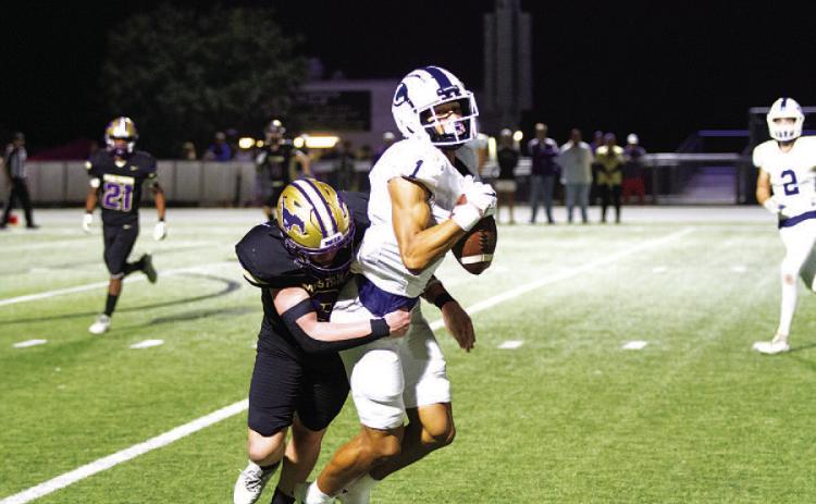 Ty Johnson makes a catch while getting hit against Marble Falls in the regular-season finale. HUNTER KING | DISPATCH RECORD