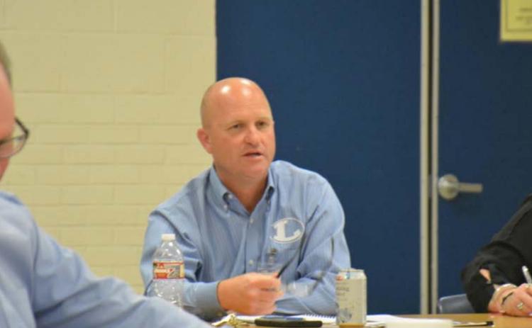 Chief Financial Officer Shane Jones, center, goes over summer school plans as board member Rob Borchardt, left, listens in and Secretary to Superintendents Joni Summers writes notes. MONIQUE BRAND | DISPATCH RECORD
