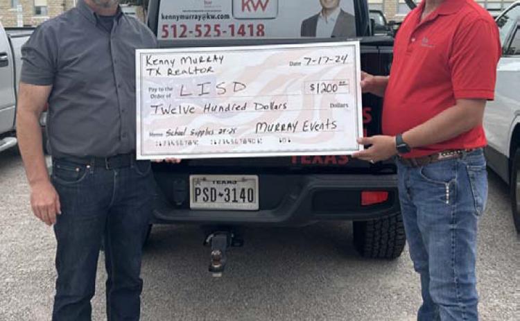 courtesy photo At left, Lometa ISD Superintendent Rob Moore and Kenny Murray showcase a $1,200 donation for school supplies to assist the district. Funds come from the Third Annual KM Scramble held earlier this summer.