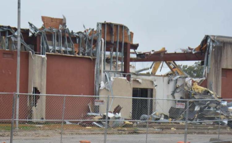 The Alamo 1 Environmental crew continues to dismantle the former Lampasas County Jail on East Fourth Street in this photo taken Monday morning. MONIQUE BRAND | DISPATCH RECORD