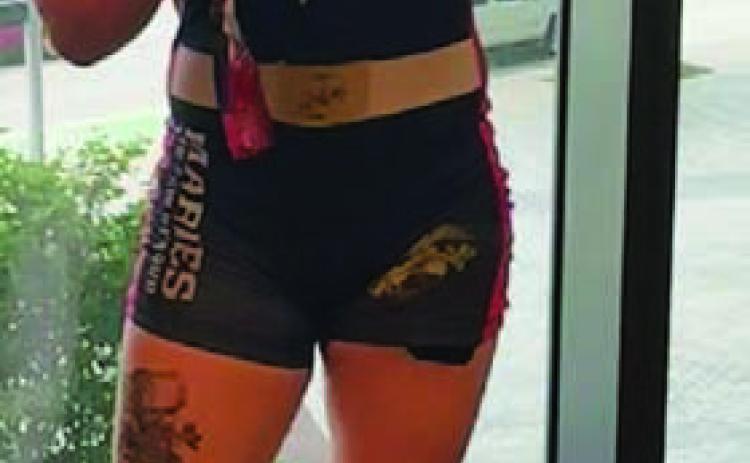 Taylor Martell poses with her medal. COURTESY PHOTO