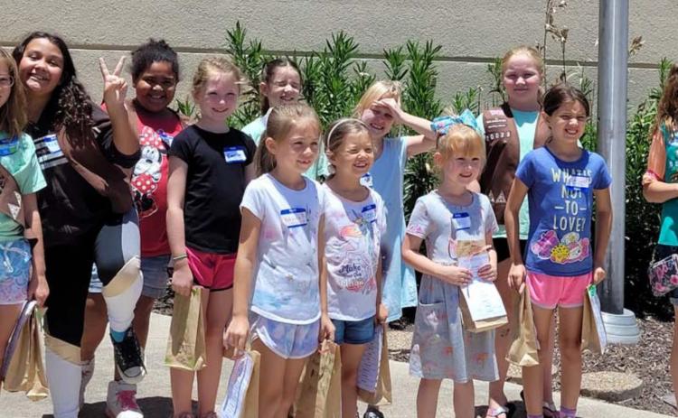 Pictured at the Lampasas Police Department building are, from left to right, Girl Scouts Jenna Paige Linney, Katelynn Rodriguez, Vera-Rose Johnson, Emerson Evans, Karma Driskell, Emma-Lee Bull, Fiona Wharton, Evelyn Peterson, Addison Hammons, Anna Figurski, Belle Wharton and Breanna Kirby. Not pictured: Jesseca Mahoney, Kayleigh Mahoney, Autumn Beavers and Gwen Carey. COURTESY PHOTO