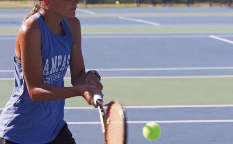 Madelynn White returns a ball on Tuesday in the tennis home opener. She won both her singles match and her doubles match with Tayler Sheard by the same score, 8-1. ERICK MITCHELL | DISPATCH RECORD