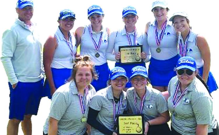 COURTESY PHOTO | JUSTIN SCHULZE The two Lady Badger golf teams pose with their district champion and district runner-up trophies after their success this week.