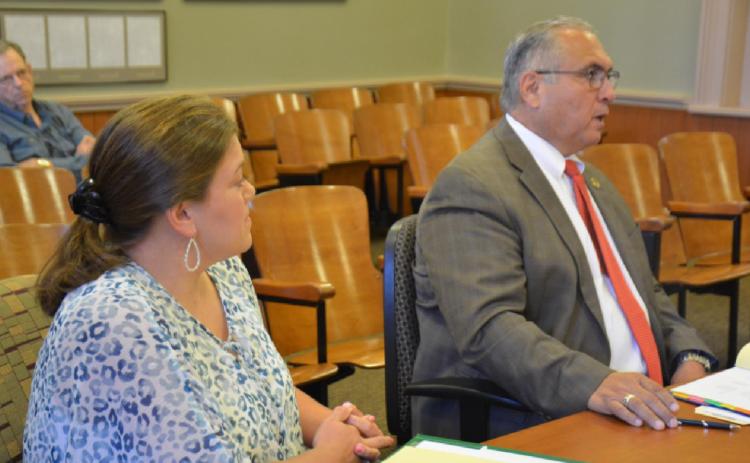 Jail Administrator Cristopher Brister, left, looks on as Sheriff Jess Ramos speaks to county officials during his budget presentation Thursday. MONIQUE BRAND | DISPATCH RECORD