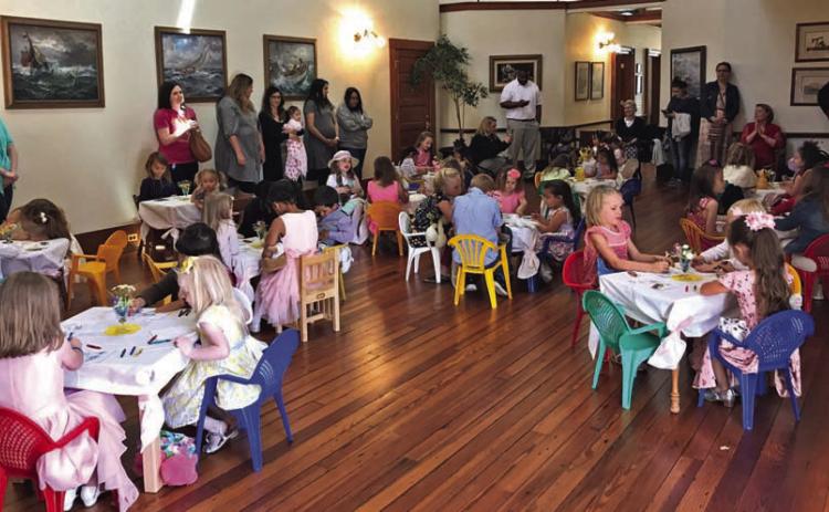 Children dressed in their party finest enjoy an afternoon tea. COURTESY PHOTO