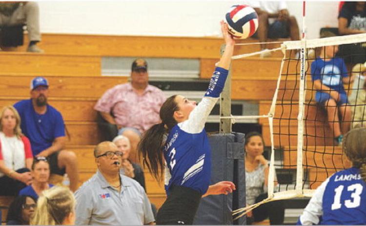Landry White rises for an attempted kill during an early-season match on the road. HUNTER KING | DISPATCH RECORD