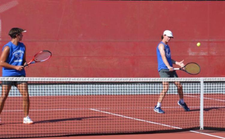 HUNTER KING | DISPATCH RECORD Elijah Copeland, right, plays a shot as Clyde Ashfield looks on during their doubles match against Glen Rose.