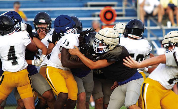 HUNTER KING | DISPATCH RECORD Ayden Vanliew meets the running back in the hole and makes a tackle against Gatesville.