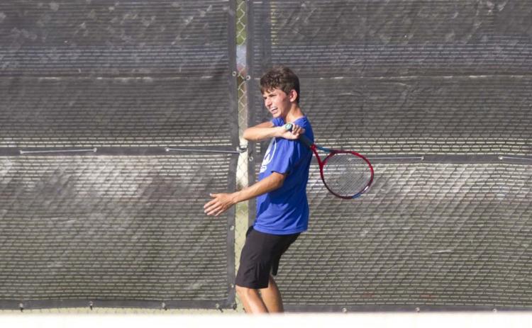 Clayton Shaw finishes on a forehand shot during a recent tennis match in Lampasas. Tennis started district play on Thursday against Stephenville. HUNTER KING | DISPATCH RECORD