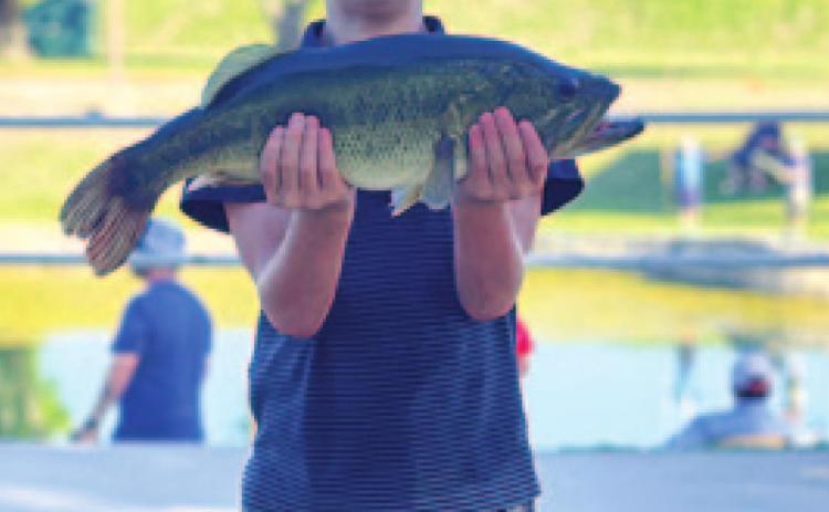 Bobby Chaney is all smiles with his catch from the fishing derby. MONIQUE BRAND | DISPATCH RECORD