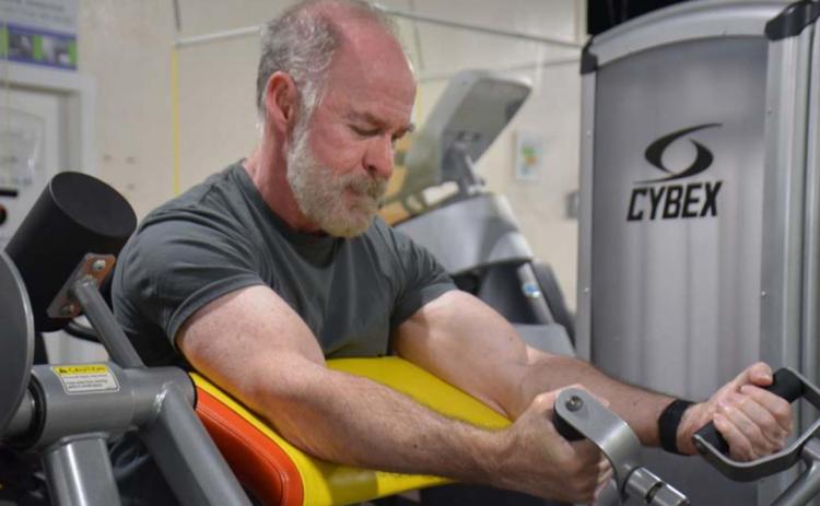 Part of Day One Fitness member Patrick Thompson’s workout routine includes arm curls. The 65-year-old is one of many Lampasans who strive to stay fit year round. MONIQUE BRAND | DISPATCH RECORD