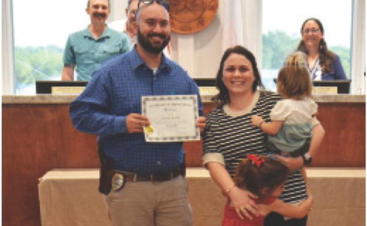 Officer Garrett Bradley was recognized at the Lampasas City Council meeting this week for his 10 years of service to the Lampasas Police Department. Pictured with Bradley are his wife and children. ANA SOFIA MEYER | DISPATCH RECORD