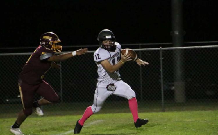 Elijah Golzales chases down the Zephyr quarterback during the Hornets’ dominant win last Friday. MEGAN LUSTY | DISPATCH RECORD
