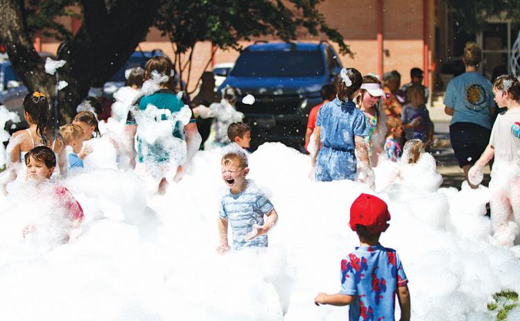 hunter king | Lampasas Dispatch Record A group of kids enjoys playing in the foam on Friday morning. Lampasas Public Library held its annual Foam Party on the library grounds.