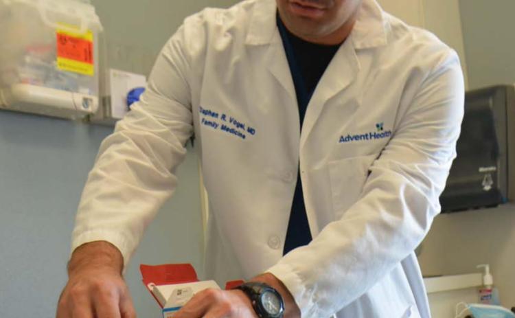 Dr. Stephen Vogel, a physician at AdventHealth Central Texas Family Medicine Clinic-Lampasas holds a Moderna vaccine in his office in this July 2021 photo. FILE PHOTO