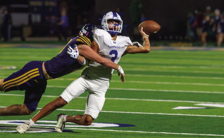 Lampasas senior receiver Tripp Stinnett attempts a double pass play before he is tackled by Stephenville’s defense. PHOTO BY ANA SOFIA MEYER