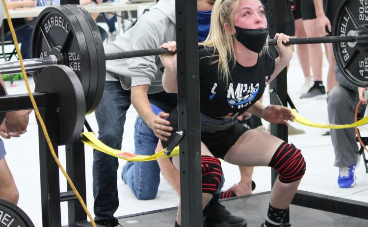 Alyssa Ayers squats 315 pounds on the way to a gold medal in the 123 weight class on Thursday. Photo by Chris Ybarra