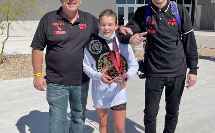 Taylor Martell, center, shows the bronze medal she earned in Arizona.