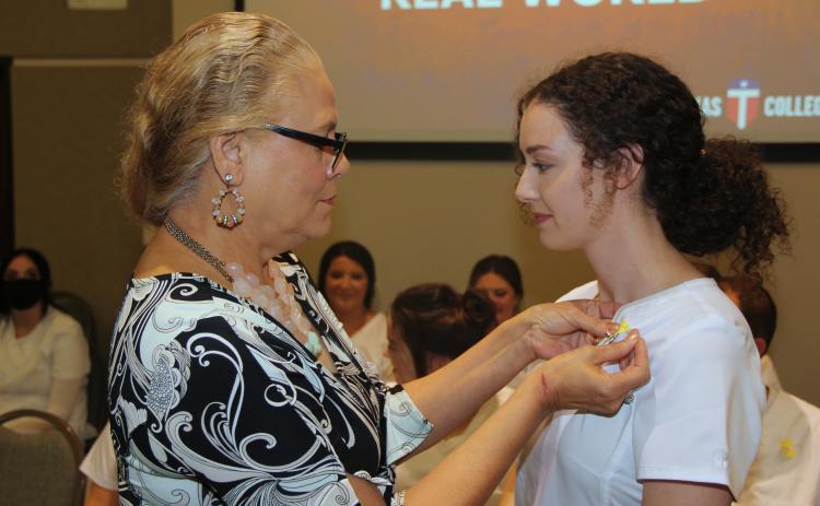  Louise Perry, Central Texas College nursing professor presents a student their nursing pin during the fall 2021 licensed vocational nursing pinning ceremony. | Courtesy Photo