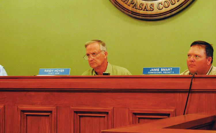 County Judge Randy Hoyer and Commissioner Jamie Smart listen to discussion on the county's burn ban.