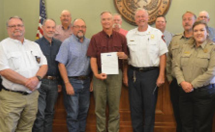 On Monday, the Lampasas County Commissioners Court approved a proclamation recognizing July as “First Responders Month.” Pictured are area first responders, Hill Country 100 Club directors and the Lampasas County Commissioners Court members.